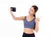 Portrait young asian woman in sportswear workout and selfie on smartphone isolated white background, girl in sportswear taking a photo on smart phone, sport and health care.