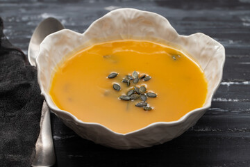 Canvas Print - Pumpkin and spinach soup in white bowl