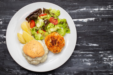 Sticker - Fried chicken meatballs with boiled vegetables on white plate