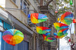 Colourful Rainbow Umbrellas Hanging Up Side Down Over Street