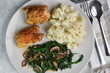 two chicken thighs with sauteed spinach and mushrooms