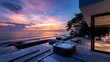 High-definition view of a modern beach villa with an outdoor hot tub on the terrace, overlooking a serene ocean at twilight.