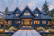 © ILOVEART - The front perspective of a striking midnight blue craftsman cottage style house, with a triple pitched roof, featuring beautifully arranged plantings and a smooth,