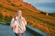 Outdoor portrait of middle age woman enjoing nice autumn day in vineyards, healthy and active lifestyle