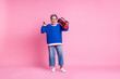 Full size portrait of nice aged lady boombox show heavy metal symbol wear blue sweater isolated on pink color background