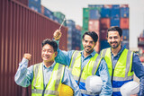 Fototapeta Na sufit - Portrait of Engineer or foreman team pointing up the future  with cargo container background at sunset. Logistics global import or export shipping industrial concept.