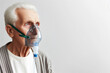 an old man in an oxygen mask on a white background copy space