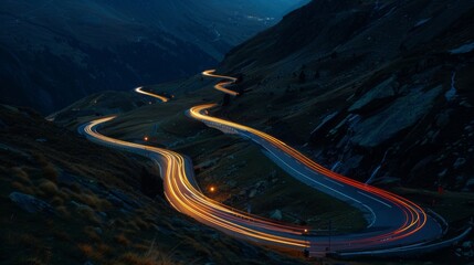 Poster - Trailing lights of cars winding along a mountain road during the dim hours of dusk
