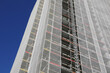 skyscraper with scaffolding during the installation of panels for thermo-acoustic insulation