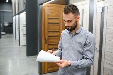 Wall Mural - sales consultant standing near the interior door