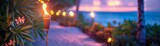 Fototapeta  - Blurry photo of a beach at sunset with tiki torches in the foreground