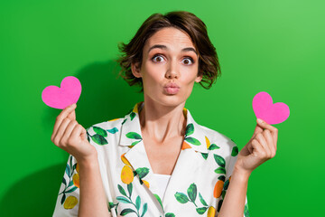 Sticker - Photo of shiny flirty lady wear print shirt rising two pink hearts sending kiss isolated green color background