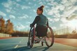 Athlete in wheelchair on track during sunset