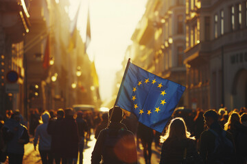 Silhouettes of people on a street parade with European Union flag.