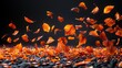   Orange leaves swirling in the air above a stack of black rocks and gravel against a dark backdrop