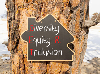 DEI diversity equity and inclusion symbol. Concept words DEI diversity equity and inclusion on blackboard. Beautiful tree background. Business DEI diversity equity and inclusion concept. Copy space.