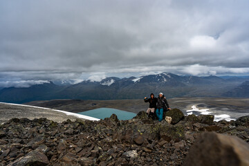 two travelers in the snowy mountains of norway. men on trekking hiking with scandinavian sticks. res