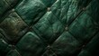   A tight shot of a green leather surface, adorned with rivets lining its edge