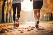 © Stavros - Keeping fit in any age. Jogging workout in autumn forest. Legs close up. Couple during jogging workout in an autumn city park.