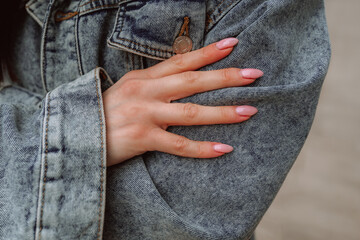 Canvas Print - Fashion details of vintage denim jacket and female hands with pink manicure