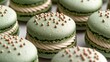   A dozen green macaroons, each topped with white frosting and colorful sprinkles
