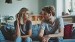 © Elchin Abilov - A young couple having a quarrel while seated on a sofa at home.