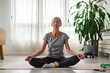 Active elderly woman practicing yoga indoors. Best Exercises for Older Women. Yoga classes for seniors.