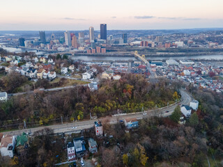 Wall Mural - Aerial cityscape with river at sunset during fall and residential Pittsburgh Pennsylvania