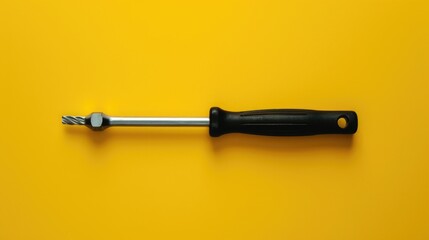 Poster - A black screwdriver against a vibrant yellow backdrop. Ideal for DIY or construction projects