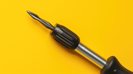 Poster - A black screwdriver on a bright yellow background. Perfect for DIY projects or construction themes