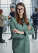 Portrait of a confident young businesswoman standing with her arms crossed in an office
