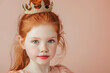 adorable redhead little girl with crown posing for a princess themed portrait