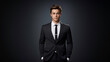 © bluebeat76 - Young professional man in a sharp suit posing against a gray background