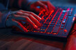 © vefimov - A person is typing on a keyboard with red keys. Concept of urgency and intensity, as the person is likely working on a task that requires quick and precise typing