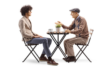 Canvas Print - Young and elderly man having coffee and talking