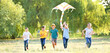 © Pixel-Shot - Children flying kite on summer day