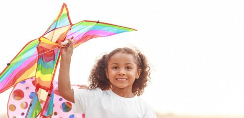 Canvas Print - Little African-American girl flying kite outdoors