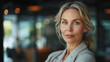 © neatlynatly - Portrait of a confident mature businesswoman looking at the camera with a subtle smile in a professional setting.
