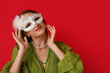 Sticker - Beautiful young woman in white carnival mask on red background