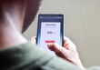 © Debalina - Man managing monthly subscription plan for streaming service or educational program or delivery benefits on his smartphone. selective focus.