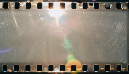Wall Mural - blank grained and scratched film strip texture background with heavy grain, dust and a light leak re