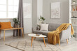 © Pixel-Shot - Interior of light living room with grey couch, table and shelf unit