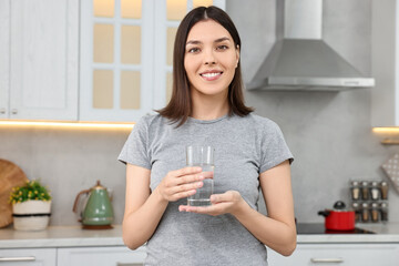 Canvas Print - Woman with glass of fresh water in kitchen