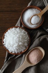 Wall Mural - Different types of organic salt on wooden table, flat lay