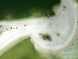 Aerial view of a sandbar among Marco Island Thousand Islands in the middle of the ocean with a boat docked
