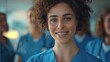 Close-up: The smiling face of a female doctor in a hospital wearing a blue uniform. Behind her is a fellow doctor. The background is blurred.Generative AI illustration.