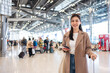 Portrait of Asian young girl walk in airport terminal to boarding gate.
