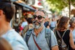 © Iigo - Portrait of smiling senior man with gray beard and sunglasses walking in the city.