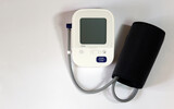Fototapeta Kosmos - Blood pressure monitor medical diagnostic device. Digital blood pressure monitoring device on a white background.
