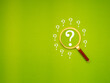 Magnifying glass with white question mark symbols against a green background.